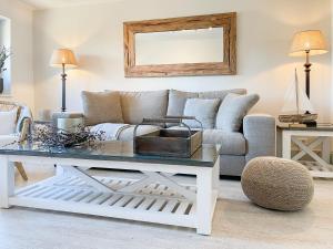 a living room with a couch and a table at Strandbude in Timmendorfer Strand