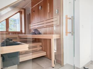 a kitchen with wooden cabinets and a glass wall at Penthouse am Hafen 2 in Niendorf
