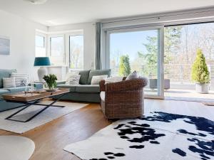 a living room with a couch and a chair at Penthouse am Hafen 2 in Niendorf