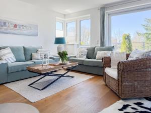a living room with two couches and a coffee table at Penthouse am Hafen 2 in Niendorf +33 photos