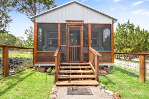 a tiny house with a staircase leading up to it at Tiny House on the Hill in New Braunfels