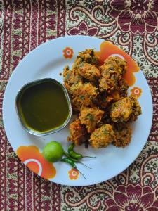 a plate of food with meatballs and a bowl of dipping sauce at Green Valley Homestay in Barkot
