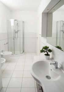 a white bathroom with a sink and a shower at ALBACHIARA INN Residence Apartments in Ameglia +116 photos