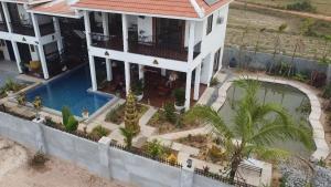 an aerial view of a house with a swimming pool at Bayon Country Villa in Phumĭ Trás Treăng