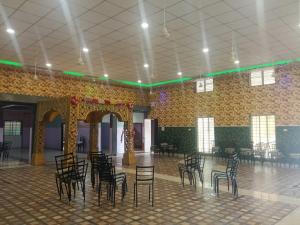 a room with chairs and tables in a building at Mangaldeep Resort and Garden in Bābai