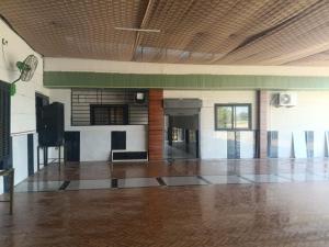 a large empty room with a dance floor in a building at Mangaldeep Resort and Garden in Bābai