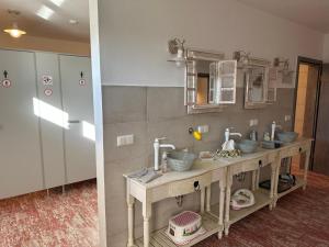 a bathroom with two sinks in a room at La Maison Pritzwalk - Bett & Bike in Pritzwalk