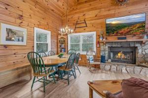a dining room with a table and a fireplace at Scooby Shack in Blowing Rock