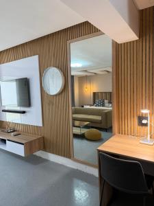 a room with a mirror and a living room at Kingdoms Lodge in Groblersdal