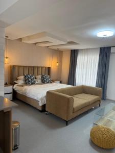 a large bedroom with a bed and a couch at Kingdoms Lodge in Groblersdal +68 photos
