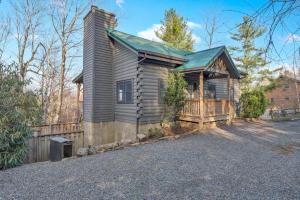 a wooden house with a porch on a driveway at Scooby Shack in Blowing Rock