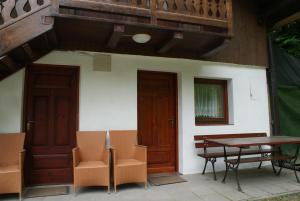 a house with two doors and a table and chairs at Dom w Kwiatach in Ojców