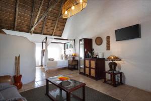 a living room with a couch and a table at Elephants Footprint Lodge in Colchester