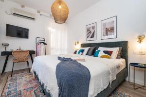a bedroom with a bed and a desk and a television at Villa La Petra in Cavtat