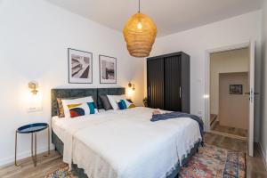 a bedroom with a large bed and a chandelier at Villa La Petra in Cavtat
