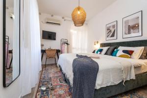 a bedroom with a large bed and a desk at Villa La Petra in Cavtat