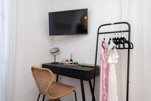 a black desk with a television and a chair at Villa La Petra in Cavtat