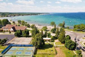 an aerial view of a building and the ocean at 1 Block to Beach | Bikes, Wellness & More in Traverse City
