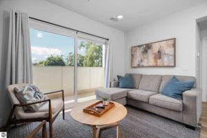 a living room with a couch and a table at 1 Block to Beach | Bikes, Wellness & More in Traverse City +18 photos