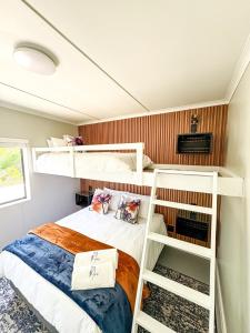 a bedroom with two bunk beds and a bed at Arc On Ray 31 in Britannia Bay