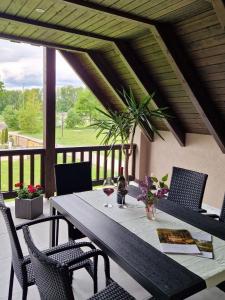 a table with a glass of wine on a porch at Ferienwohnung Spreewaldglück in Burg
