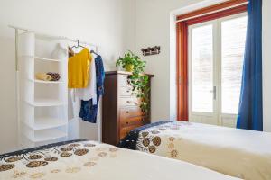 a bedroom with a bed and a dresser and a window at Dimora Santamarea in Torre Santa Sabina