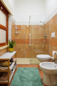 a bathroom with a shower and a toilet and a sink at Dimora Santamarea in Torre Santa Sabina +27 photos