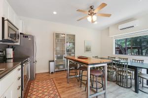 a kitchen with a table and a ceiling fan at Three Sisters - Casita 2 in Wimberley