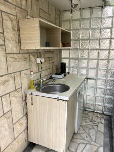a bathroom with a sink and a stone wall at Rooms Villa Desa in Budva +130 photos
