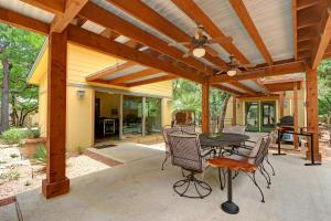 a patio with a wooden pergola with a table and chairs at Three Sisters - Casita 1 in Wimberley