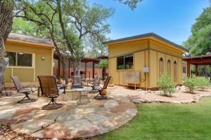 a patio with chairs and a fire pit in a yard at Three Sisters - Casita 1 in Wimberley