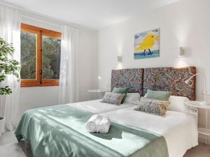 a bedroom with a bed with two towels on it at Casa del Capitán in Santa Ponsa