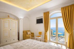 a bedroom with a bed and a balcony at Le Contrade by Sosòre Holiday Homes -Amalfi Coast in Furore