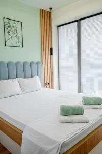 a large white bed with two pillows on it at Cozy and Stylish Apartment 3 in Stara Zagora