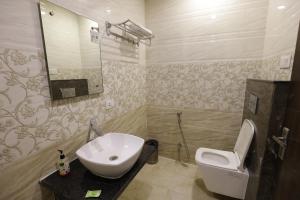 a bathroom with a sink and a toilet at Hotel Taj Venture Agra in Agra +14 photos