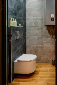 a bathroom with a toilet in the corner at Cozy and Stylish Apartment 3 in Stara Zagora +23 photos