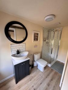 a bathroom with a sink and a toilet and a mirror at The World's End in Lowdham +16 photos