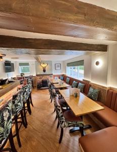 a dining room with wooden tables and chairs at The World's End in Lowdham