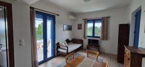 a living room with a couch and a table at Villa Avra - Apartment Hydra in Asgourou
