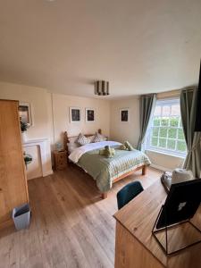 a bedroom with a bed and a large window at The World's End in Lowdham