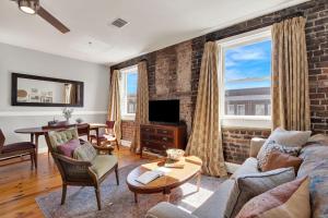 a living room with a brick wall at Above Broughton St 3002 in Savannah
