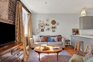 a living room with a couch and a table at Above Broughton St 3002 in Savannah