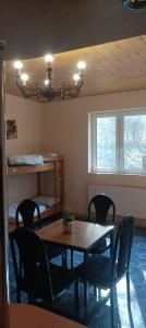 a dining room with a table and chairs and a bed at Magura Camp in Małastów