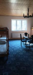 a room with a bed and a table and chairs at Magura Camp in Małastów