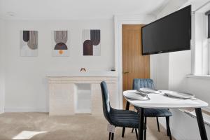 a dining room with a table and two chairs at Seaside Snug in Largs