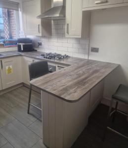 a kitchen with a large wooden island in the middle at Oakfield Gardens NY in Edmonton