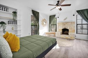 a living room with a bed and a fireplace at The Tilted Texan in Buda