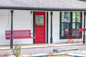 a red door and a red chair on a house at The Tilted Texan in Buda +34 photos