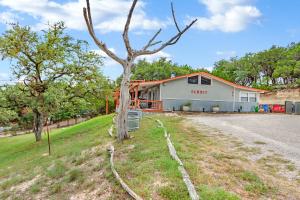 a house on a hill with a tree at The Summit in Wimberley
