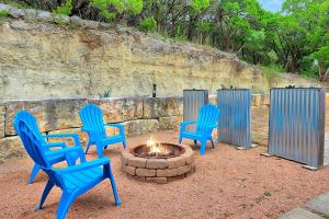 three blue chairs sitting around a fire pit at The Summit in Wimberley